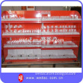 Retail cosmetic display rack with pusher system